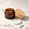 30ml 50ml 100ml Clear Amber Black Empty Eye Face Cream Moisturizer Container Glass Cosmetic Jar With Bamboo Wood Plastic Lid